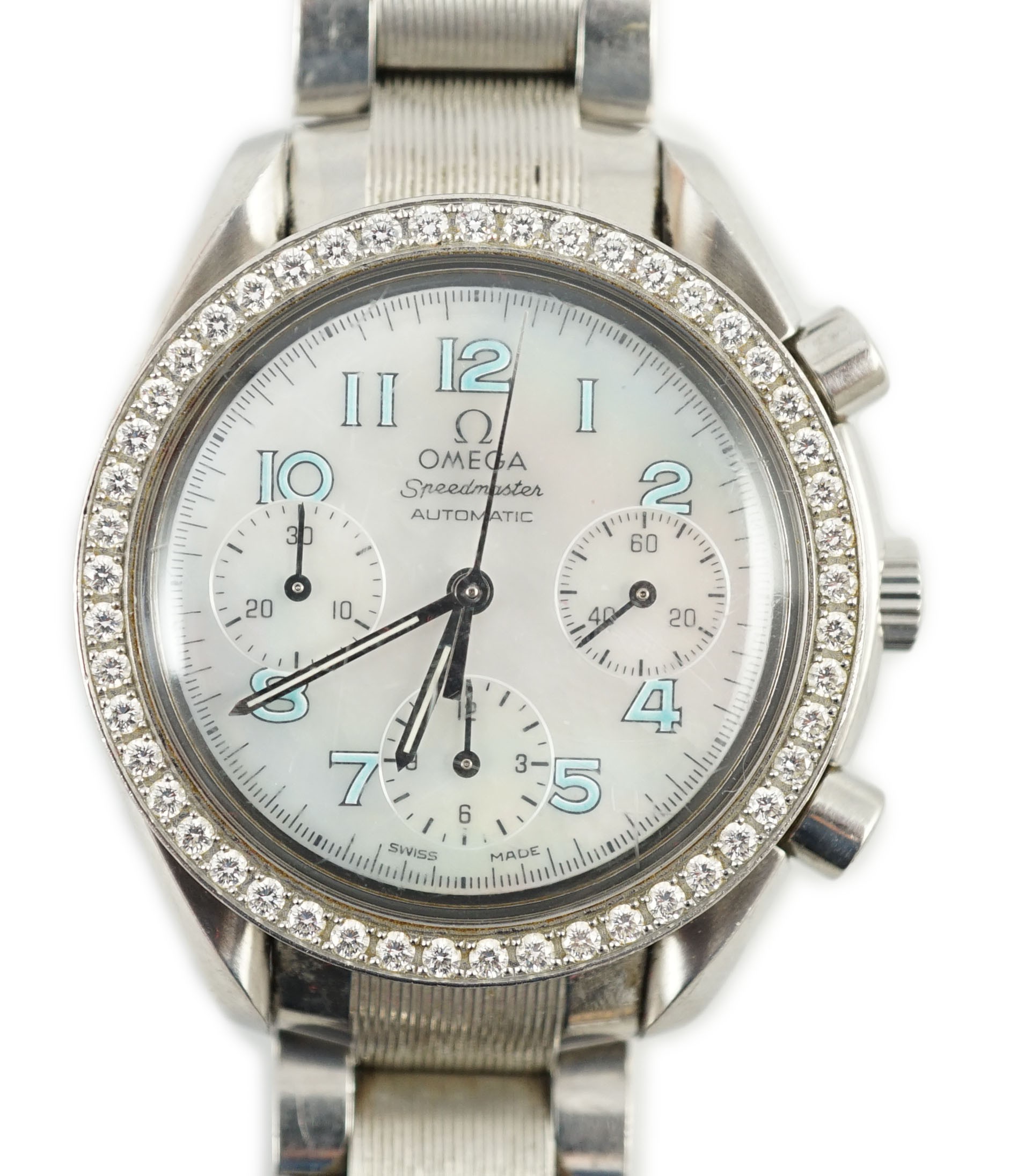 A lady's modern stainless steel Omega Speedmaster automatic wrist watch and bracelet, with mother of pearl Arabic dial and diamond set bezel